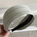 Close-up of wide striped headband in muted green with premium cotton linen texture - Headband / Light Green