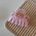 Detail view of pink jelly hair claw clip with subtle glitter on a woven background - Pink Glitter Jelly - Jellyfish
