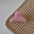 Detail view of pink jelly hair claw clip with frosted texture on woven mat surface - Pink Glitter Jelly - Triangle