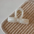 Detail of creamy white jelly hair claw clip with bow design and pearlescent finish - White Glitter Jelly - Basic Knot