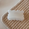 Macro shot of cream white jelly hair claw clip with subtle shimmer and wave design - White Glitter Jelly - Biscuit Shape