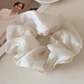 Detail view of cream organza hair scrunchie with floral and bow embroidery texture - Creamy White (Standard Scrunchie)