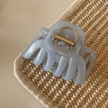 Detailed view of light blue jelly hair claw clip with golden metal spring and smooth texture - Glitter Jelly Blue - Jellyfish Shape