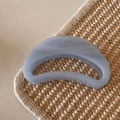 Detailed view of blue jelly glitter shark hair clip with marble texture on woven mat - Glitter Jelly Blue - Crescent Shape