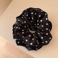 Detailed view of polka dot satin scrunchie showing delicate ruffle edges and texture - Polka Dot Ruffle Scrunchie - Black