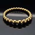Anillo minimalista de acero inoxidable dorado con cuentas graduadas y acabado pulido - US 7 / Dorado
