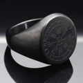 Macro view of a matte black Viking compass ring with engraved runes on stainless steel surface - US 7 / Black