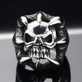 Close-up of a punk-style skull ring with eagle claws in polished silver-toned steel - US 7 / Steel