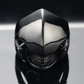 Punk style skull mask ring in black plated stainless steel on a dark reflective background - US 7 / Black