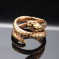 Macro shot of rose gold snake ring detailing scales and texture with reflection - Size 7 / Rose Gold