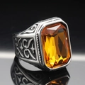 Macro detail of men's vintage steel ring featuring amber gemstone and engraved scrollwork - Size 7 / Vintage Yellow Gemstone