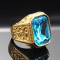 Macro view of men's gold plated ring with blue emerald cut gemstone and embossed details - Size 7 / Gold Aqua Blue Gemstone