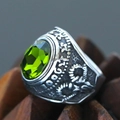 Macro shot of punk style stainless steel ring with faceted green oval gemstone and embossed detail - Size 7 / Sulfurized Distressed Relief Style (Steel Style 27) / Steel Color (Green Gemstone)
