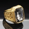 Macro shot of gold-plated men's ring with large emerald-cut black gemstone and relief details - Size 7 / Gold Mineral Black