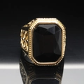 Macro shot of men's vintage gold ring with large octagonal black gemstone and carved details - Size 7 / Gold Black