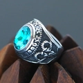 Macro shot of a vintage punk ring with a large oval teal gemstone and embossed details - Size 7 / Gothic Ethnic Style (Steel Style 18) / Steel (Teal Gemstone)