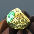 Macro close-up of a vintage punk gold ring featuring a large green faceted gemstone - Size 7 / Emerald Green Rhinestone Relief Style (Gold Style 28) / Gold