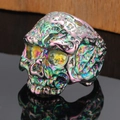 Detailed macro view of punk skull ring with iridescent electroplated rainbow finish - Rainbow