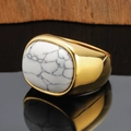 Macro view of wide gold alloy ring featuring a large oval marble texture stone - Gold White Turquoise