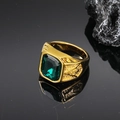 Macro detail of vintage gold seal ring featuring emerald green gemstone and engraving - Gold Green