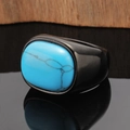 Exaggerated wide band ring with turquoise and gunmetal finish on a dark mirror surface - Black Color Turquoise
