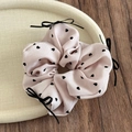 Detailed close-up of pink scrunchie with black hearts and bows on a tray - Heart Polka Dot Bow - Pink
