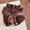Close-up of velvet scrunchie texture with a small gold metal pendant on card - Large Gold Label / Dust Rose
