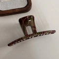 Detail shot of vintage plaid hair claw clip in red and green acetate texture - Hollow Bar