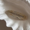 Detail view of cream marble acetate hair clip on a decorative white shell tray - Beige Marble Oval