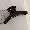 Close-up of leopard print hair claw clip made of glossy brown and black resin - Shimmer Brown Leopard Thick Bar