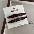 Detail of sweet handmade cherry hair clips with red plaid fabric on white card - Linear