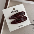 Close-up of sweet cherry hair clips with red checkered fabric on vintage linen display - Water Drop