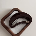 Detail view of large chocolate brown shark hair claw clip with golden Barrette LaFrance logo - Chocolate-Crescent