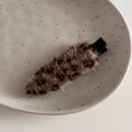 Close-up of leopard print plush hair clip on a minimalist ceramic plate display - Sparkly Leopard Coffee