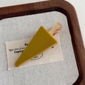 Close-up of mustard yellow triangular acrylic hair clip with gold metal base on wood - Yellow