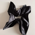 Detail of a handmade black satin silk scrunchie with a visible hand made textile label - Solid Satin / Black Large Scrunchie