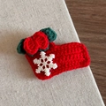 Detail of handmade crochet Christmas sock hair clip with red yarn and white snowflake - Red Christmas Sock