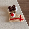 Close-up of handmade crochet reindeer hair clip with cute antlers and red nose for Christmas - Reindeer Pattern