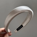 Detail showing hand holding a champagne satin padded headband with a handmade label - Solid Satin / White Headband