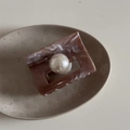 Detail of marble pattern hair claw clip with large pearl on minimalist ceramic tray - Ink Texture Coffee Rectangular