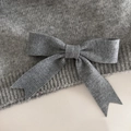 Detailed close-up showing the fine knit texture and bow craftsmanship of the gray hair clip - Light Gray