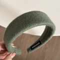 Close-up of handmade wide padded hairband in dark green wool fabric with inner label - Green
