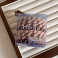 Detail of high-elasticity braided hair bands in earth tones inside a clear branded box - Twill Apricot Coffee