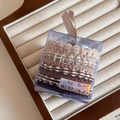 Detail of high-elasticity hair bands in coffee tones within a clear gift box with ribbon - Beige and Coffee Weave
