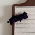 Close-up of vintage purple velvet scrunchie with elegant black bows on a jewelry tray - Charming Purple Velvet BB Clip