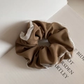 Close-up of brown scrunchie with white organza trim and delicate pearl beads - Caramel color