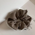 Detail of grey fabric scrunchie with white lace trim and delicate pearl embellishments - Brown