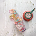 Macro shot of colorful hair rubber bands spilling from a floral rose pattern container - Red