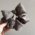 Macro shot of large dark grey bow scrunchie showing fabric texture and pleated detail - Bowknot Scrunchie / Coffee
