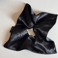Detail view of smooth black satin scrunchie with 100% polyester wash label - Square Scrunchie / Black